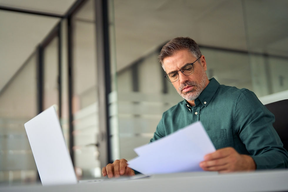 Man reviewing his monthly expenses using The Debt Action Plan - monthly expenses under control.