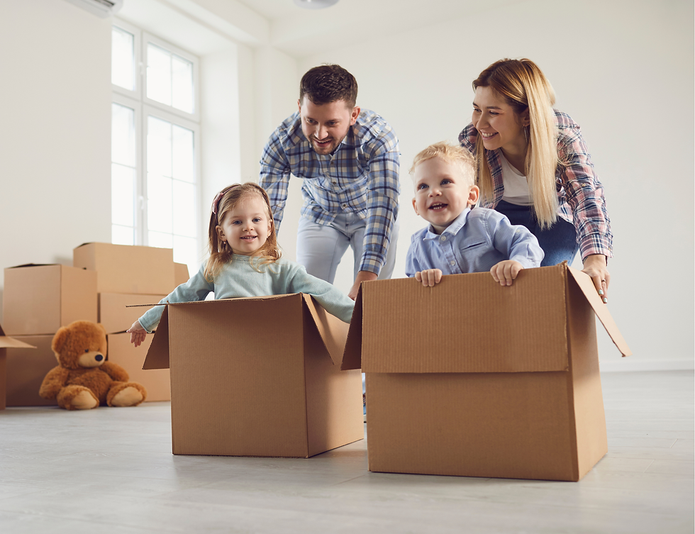 A young family playing with their kids in their new home.