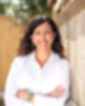 Image of Diet Matters founder Isabelle Fry standing next to a fence outside wearing a white blouse and smiling at the camera