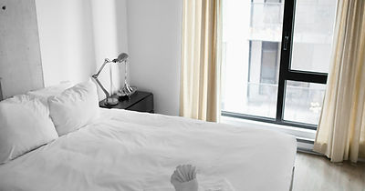 Freshly made bed in a city apartment