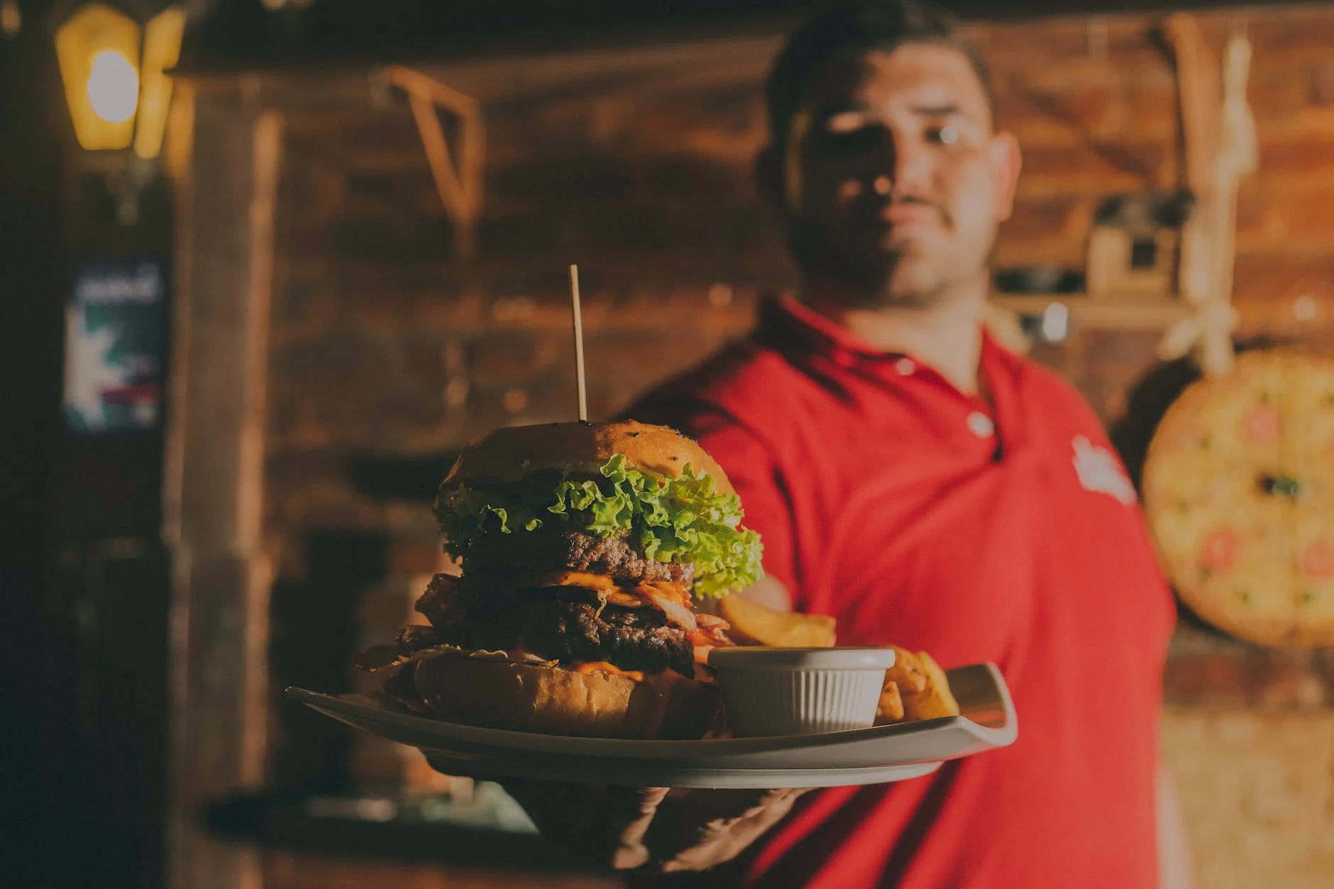 Man Holding A Plate With A Cheeseburger On It Photo by Edward Eyer