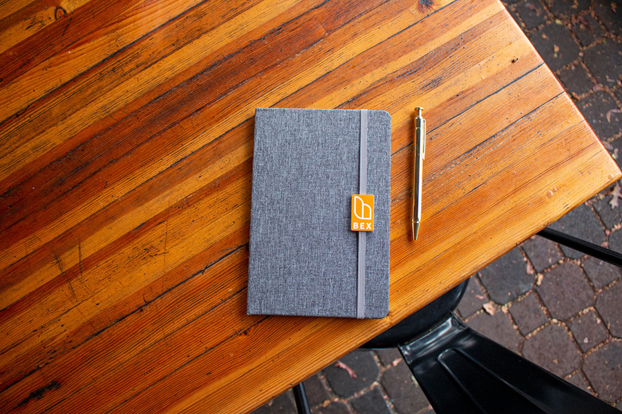 Journal and pen on an outdoor wood table