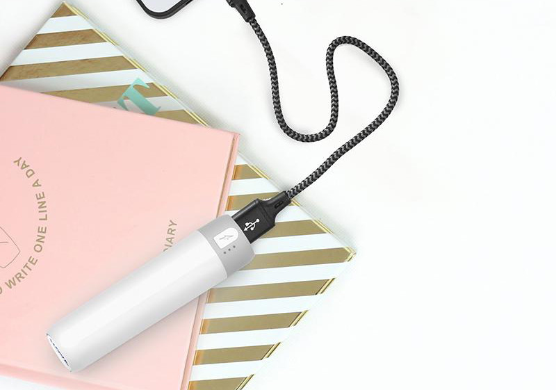 portable power bank resting on set of notebooks