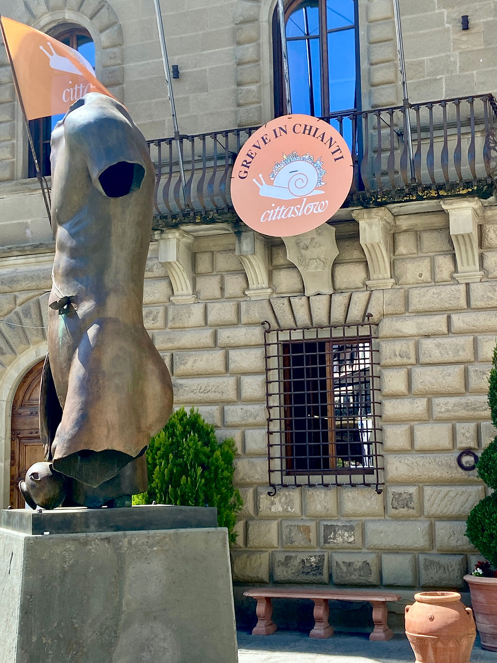 The Citta Slow flag and logo hang proudly on the Palazzo Comunale (City Hall) in Greve in Chianti.  The bronze sculpture is by Igor Mitora.