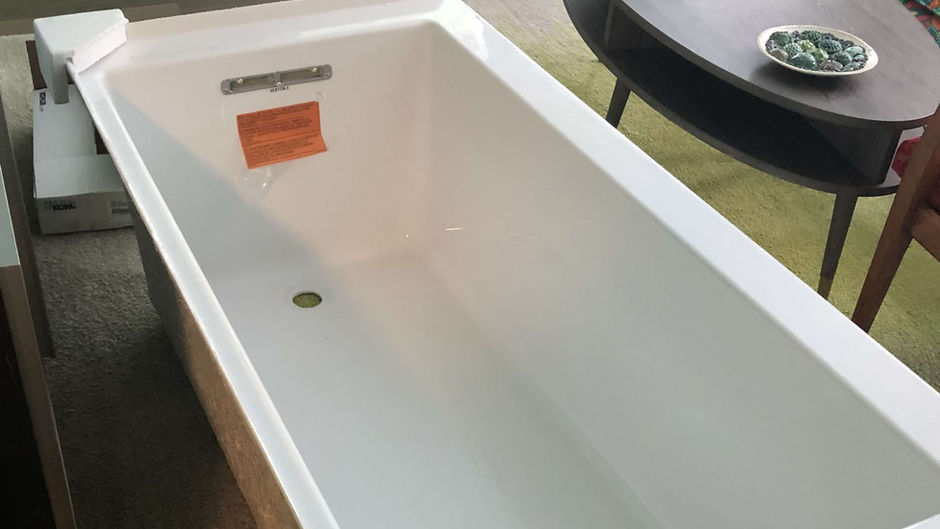 Unboxed bathtub awaiting installation