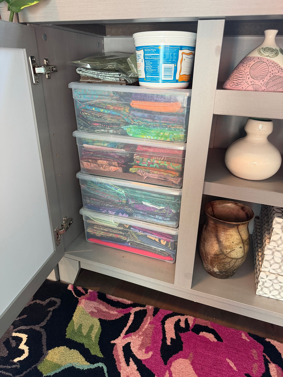 Quilting supplies in a gray cabinet