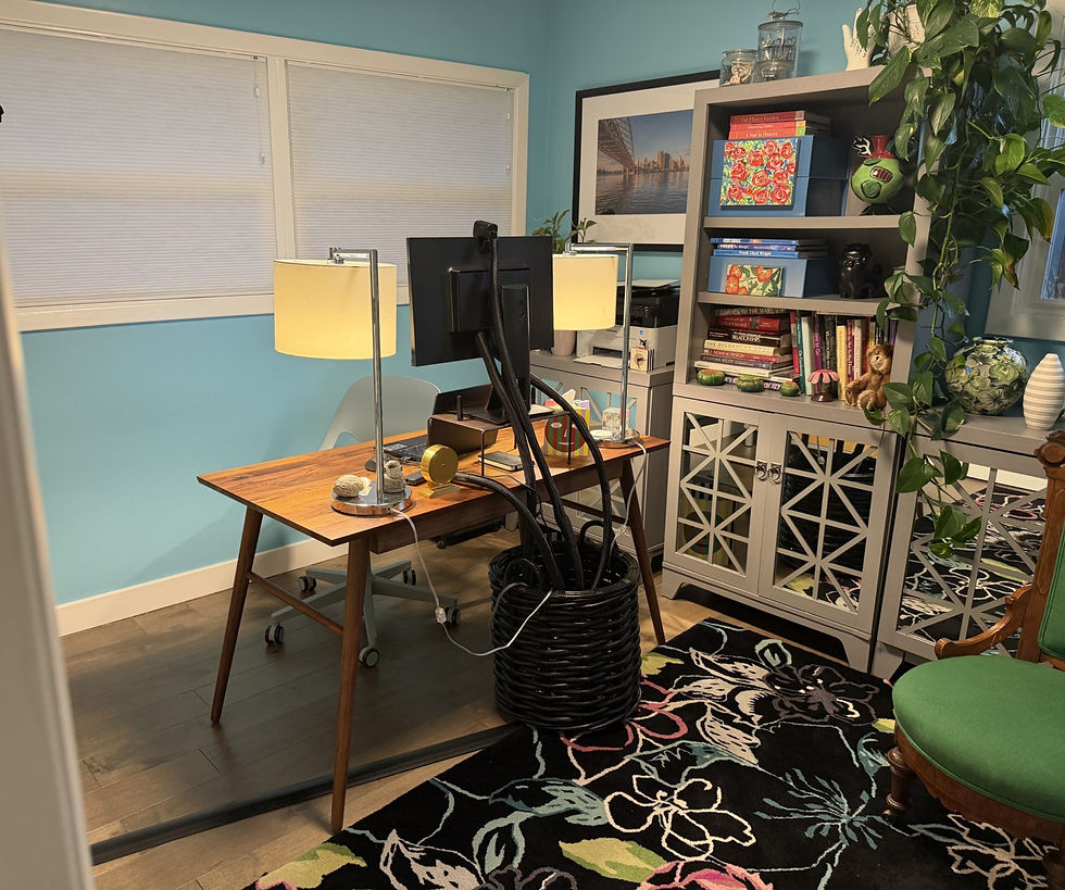 Home office with blue walls and a floral area rug.