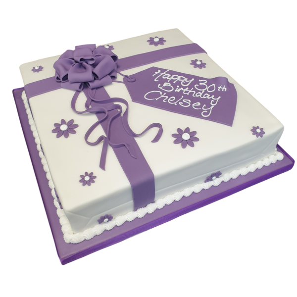 Luxurious and decadent 12" parcel-shaped cake perfect for special occasions. Frosted with smooth buttercream and decorated with intricate details.