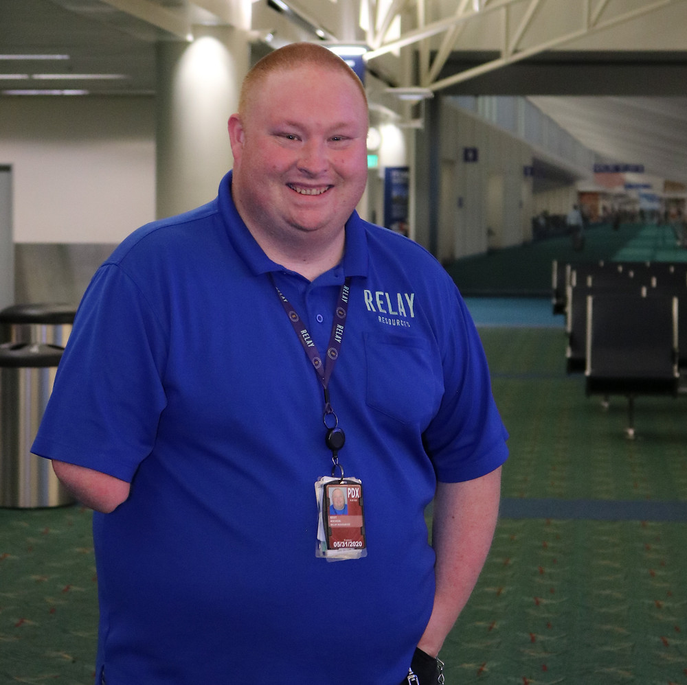 Michael Best stops for a photo after becoming a job coach at PDX airport.