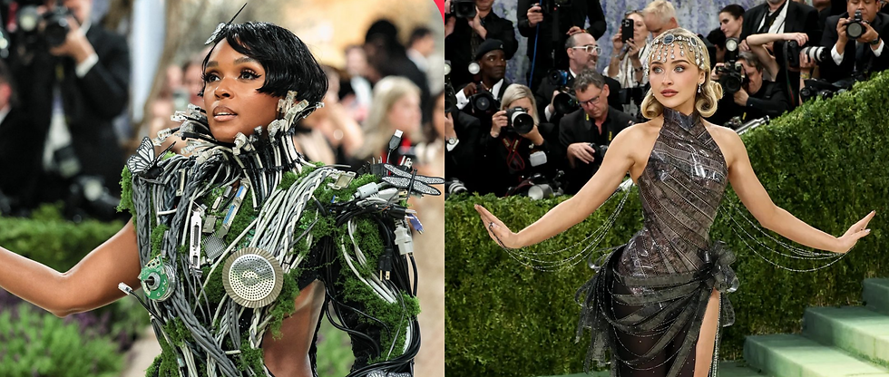 Two individuals in elaborate outfits pose on the red carpet. One wears a tech-inspired dress with green elements, the other in shimmering silver and jeweled headpiece. Photographers in the background.