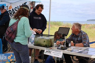 People gather around a tank on a table and smile.