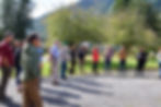 A group of people gather in the sunshine.
