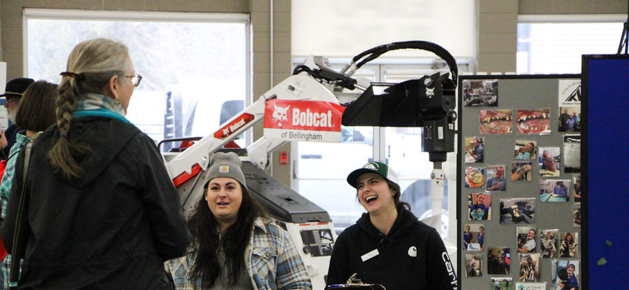 Exhibitors laughing with visitors