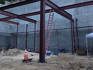 Construction sight with steel beams that had installation by professional welders.