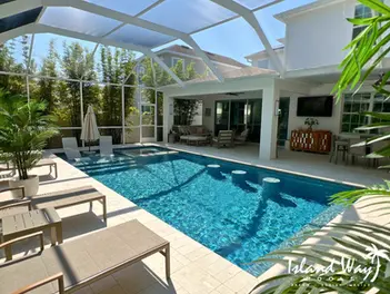 Linear Pool Featuring A Sunshelf, Flush Spa, Barstool Seating, & Shellock Decking In Safety Harbor Florida