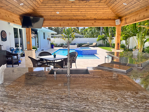 Linear Pool with a raised spa, pergola, and outdoor kitchen