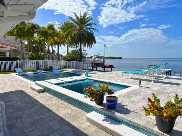 Linear Pool With A Spillover Spa, Floating Steps, Sunshelf, and Belgard Pavers