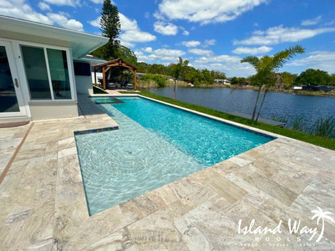 Linear, Waterfront Pool With Travertine Decking In Pasco County