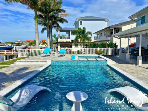 Custom Linear Pool Project Featuring, A Sunshelf, A Spillover Spa, Floating Steps, Tiled Cascading Feature Wall, And A Raised Sun Deck In Palm Harbor