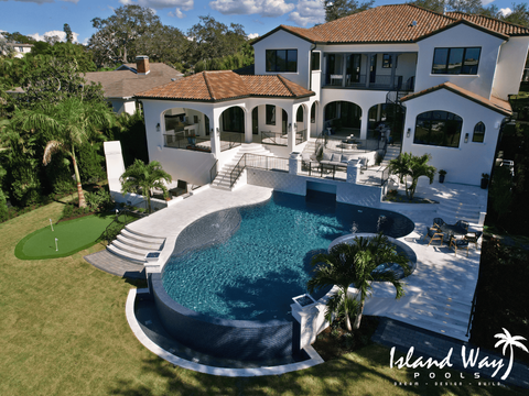 Freeform Infinity Edge Pool Featuring A 360 Spillover Spa, Italian Marble Decking, Firebowls, A Putting Green, & A Sunshelf In Belleair Florida