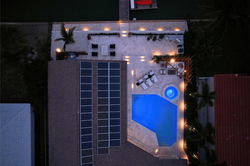 Drone shot of outdoor living space with landscape lighting