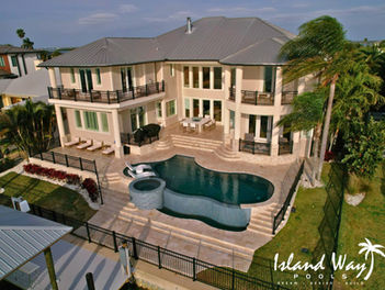 Infinity Edge Pool With A Spillover Spa, Sunshelf, & Travertine Decking In Clearwater Beach