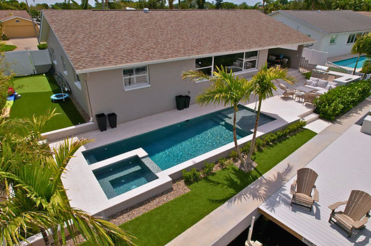 Linear Pool Project With Turf And An Outdoor Kitchen
