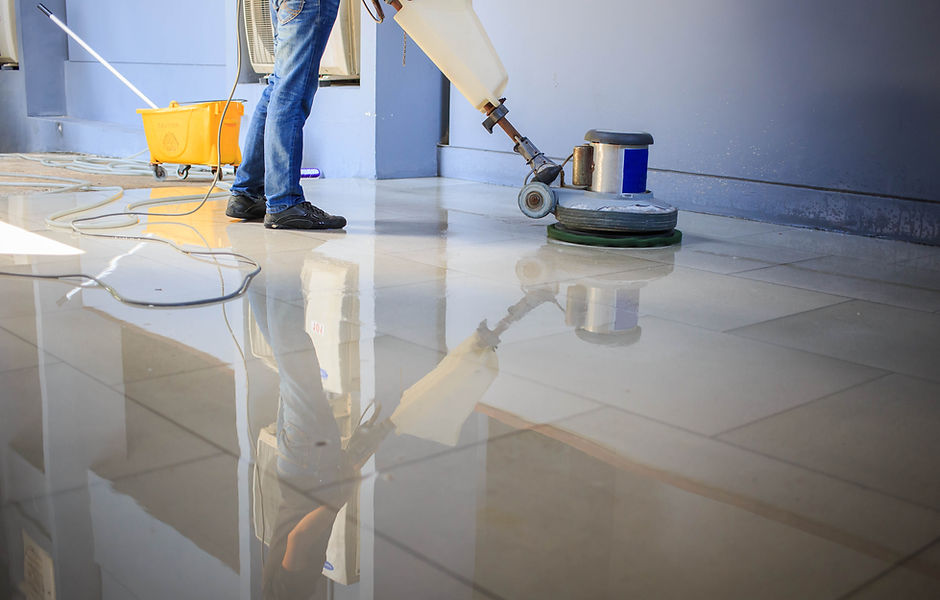 The people cleaning floor with machine..