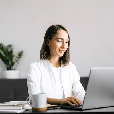 happy-young-woman-sitting-at-the-table-a
