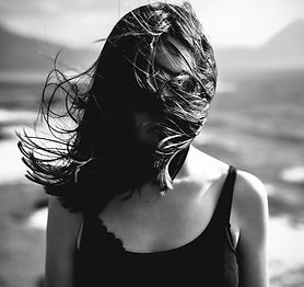 Woman with Hair Blowing Over Face