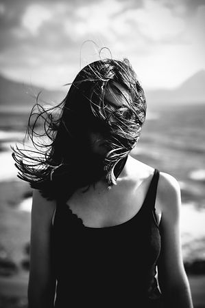Woman with Hair Blowing Over Face