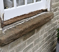 A stone cill sill in need of urgent repair on a listed property in Bollington, Chesire