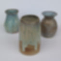 Three blue vases on a white background