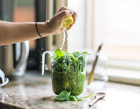 Glass of green juice on table
