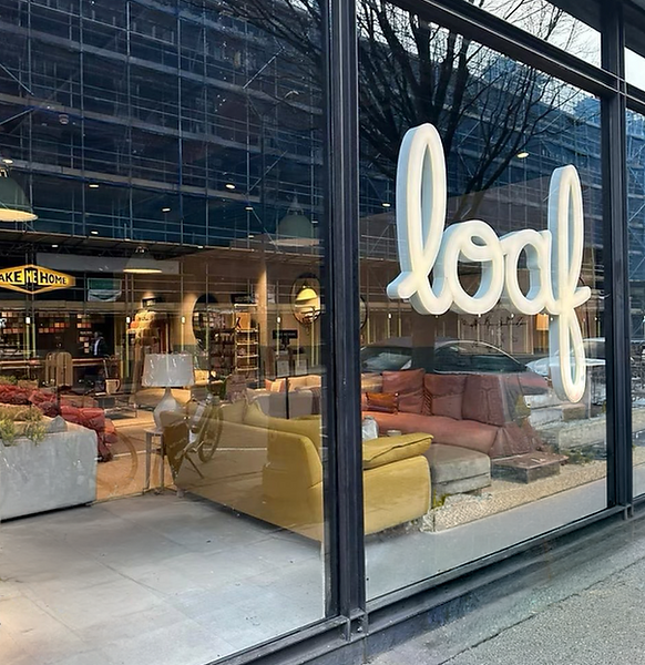 Loaf furniture store exterior with logo on large glass window display