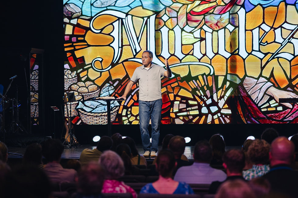 Pastor Mark Yoder preaches from the Bible at a Christ Community Church service.