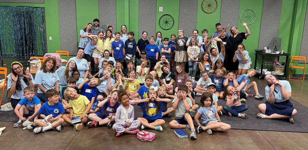 Children and volunteers at Illuminate take a silly photo