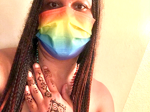 Allison Coleman celebrating Pride Month while traveling, smiling outdoors with rainbow colors and Dream Worldtrotter spirit