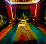 Candlelit resort spa at night framed by red curtains, a wellness travel retreat