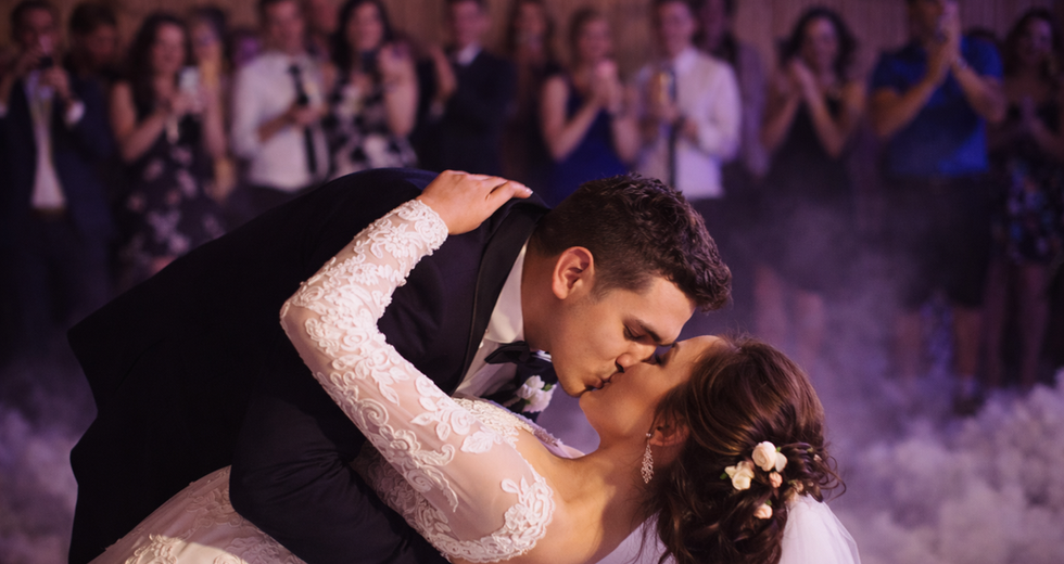 Bride and groom sharing a dramatic first dance dip