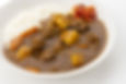 A plate of Japanese curry rice, featuring thick curry sauce over rice with vegetables and meat.