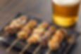 Skewered and grilled pieces of chicken, seasoned with salt or a sweet soy sauce.