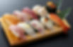A piece of nigiri sushi with fresh raw fish on top of vinegared rice.