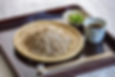 A bowl of soba noodles made from buckwheat flour, served hot in broth or cold with dipping sauce.