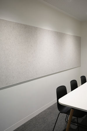 A single horizontal acoustic panel in light grey was installed by BACH Commercial at Caulfield Grammar School in the study room, behind a table and chairs.