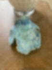 Handbuilt pottery trinket bowl in blue glaze with sculptural ruffled edges and organic marbled surface texture