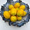 Thumbnail: A blue ceramic bowl with ruffled edges, with lemons in the middle