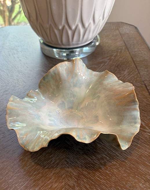Organic ceramic accent bowl for modern interiors with sea‑glass green glaze and sculptural ruffled rim.