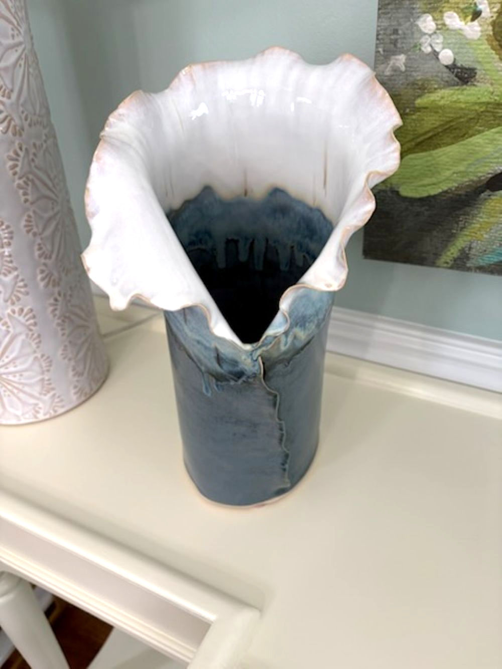 Sculptural ocean blue ceramic vase in handbuilt stoneware with a fluted white ruffled edge.