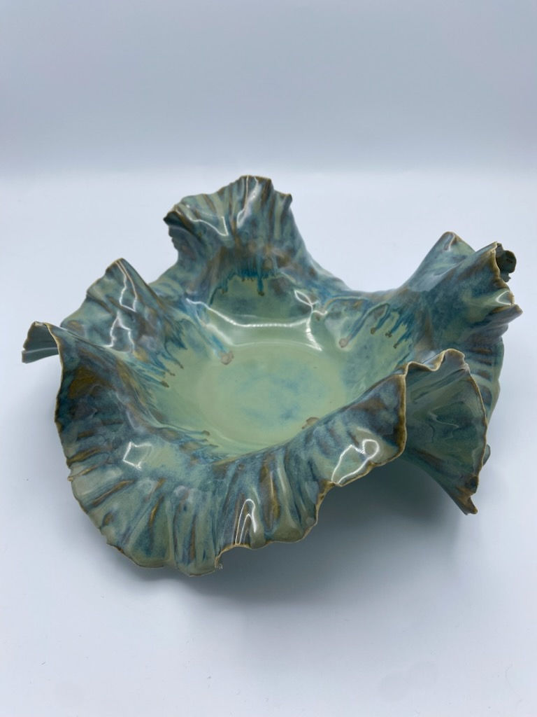 Handbuilt ruffled ceramic bowl in blue green earth tones with sculptural rim and glossy organic glaze texture